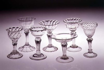Collection of pedestal sweetmeal glasses, left to right: quilted ogee bowl, 1740; double ogee bowl, 1730; flared double ogee bowl with silesian stem, 1730; saucer bowl with silesian stem, 1740 by English School